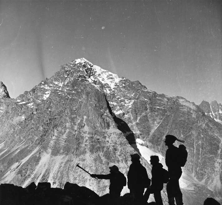 Silhouettes of mountain climbers against the background of the mountains