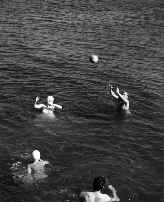 Swimmers playing in the water near Pictou Lodge