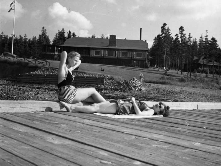 Two women sunbathing on the pier, Pictou Lodge