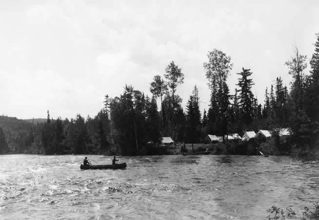 Canoeists approaching Pine Portage Camp, Nipigon River