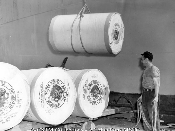 Rolls of newsprint being lifted to ship