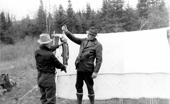 Fisherman with grey trout, Burnt Lake
