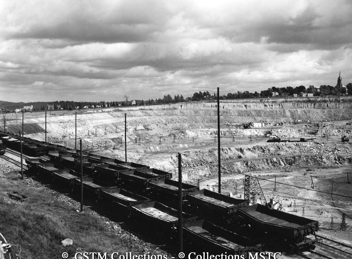 Mining cars alongside open pit of asbestos mine