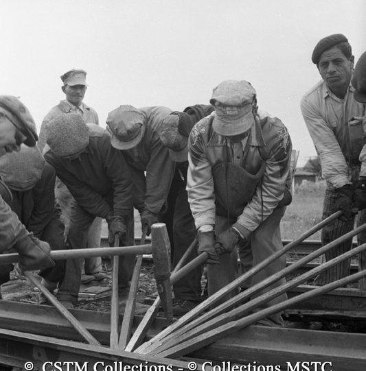 Track gang working together to relay track at Dauphin, Manitoba