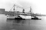 Passenger ship S.S. Lady Rodney with tugs in Boston Harbour