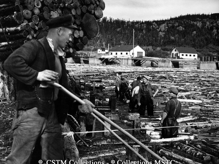 Lumbermen loading two-cord bundles of logs at Bowater’s Newfoundland Pulp and Paper Mills Limited loading plant at Howards, 20 miles from Corner Brook