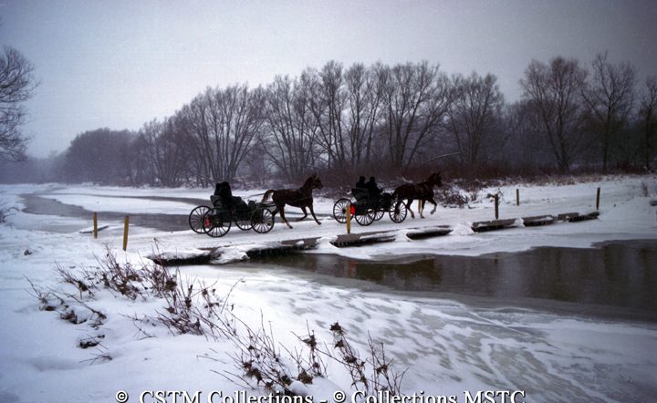 Mennonites in horse drawn buggies crossing the Conestoga River