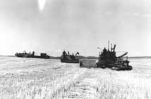 Self-propelled and pull combines at work in Saskatchewan