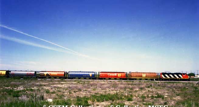 Grain train with hopper cars in six different paint schemes