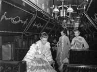 Costumed employees walking through the sleeping car of the Museum Train