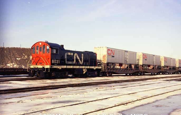 Diesel locomotive S-4 8031 switching piggyback cars in Turcot Yard, Montreal.  Locomotive built by Montreal Locomotive Works in 1954
