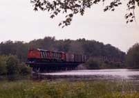 Diesel locomotive M-420 2505 and 2503 in the new striped paint scheme with a freight train on Cantic Trestle
