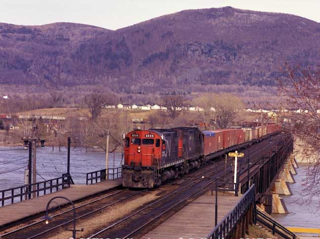 Diesel locomotives M-424 3205 and 3211 with a container train on Beloeil Bridge