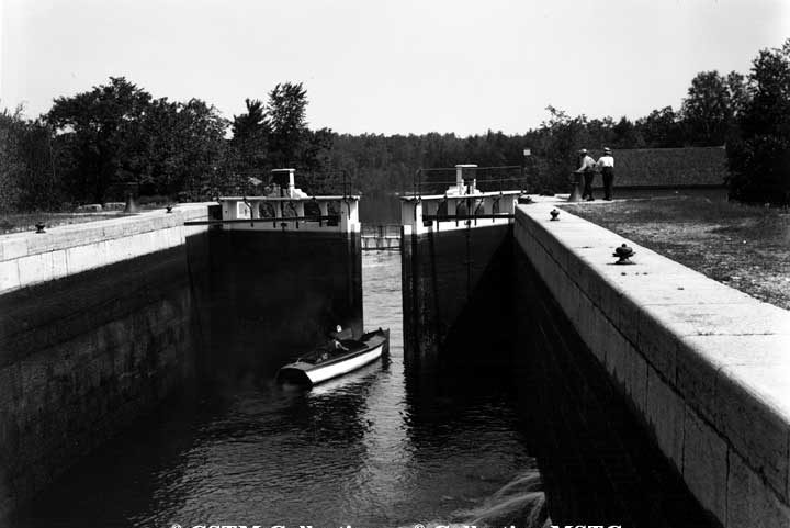 Small boat passing through the Burleigh Falls Lock, Kawartha Lakes, Ontario