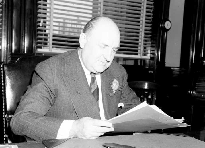 R.C. Vaughan seated at his desk