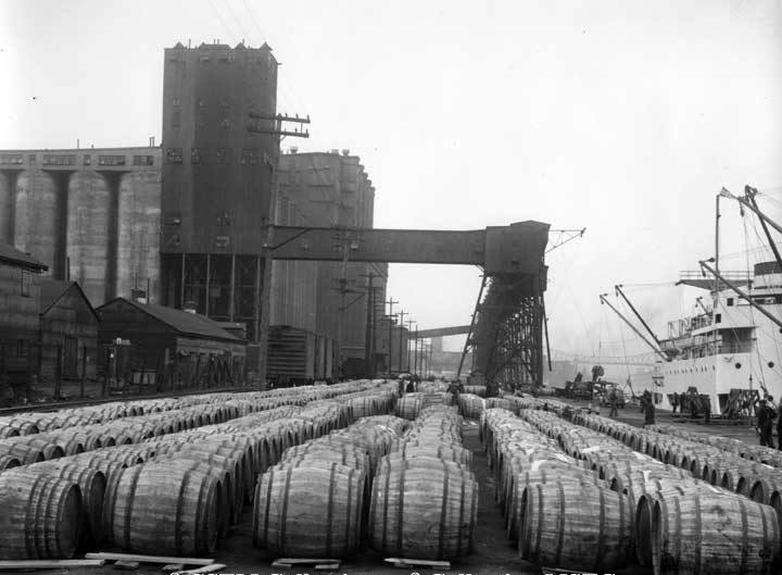 Barrels of molasses unloaded from a Canadian National Steamship