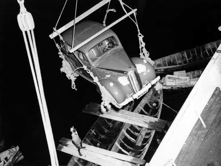 Automobile being lifted from the water onto the C.N.S.S. Lady Rodney