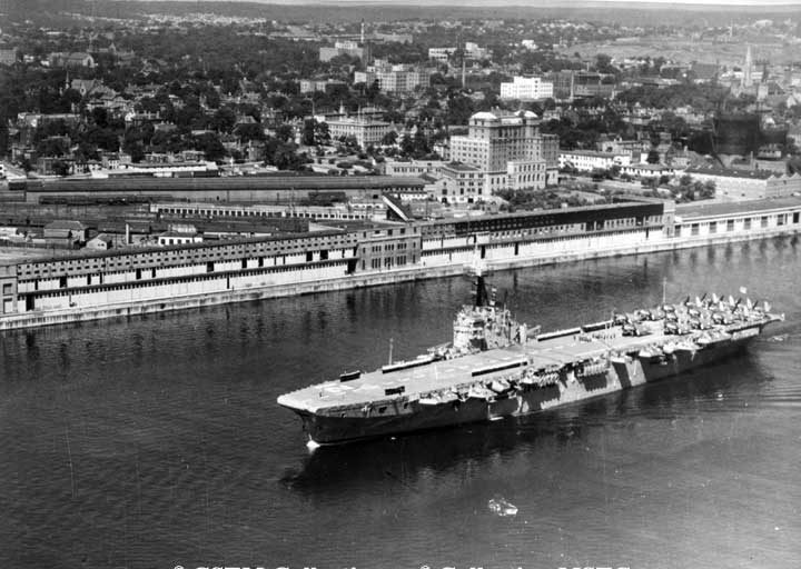 HMCS Magnificent proceeding seaward past the Nova Scotian Hotel and Pier 21