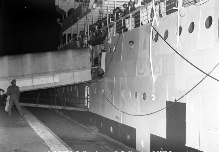 Troops wait to disembark the C.N.S.S. Lady Nelson docked at Pier 21