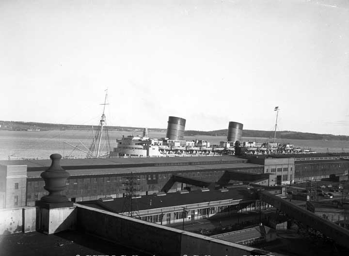 Pier 21with troop ship S.S. Queen Elizabeth in the background