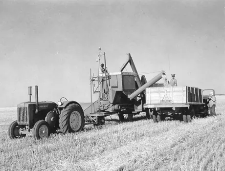 Unloading grain from pull-type combine into truck