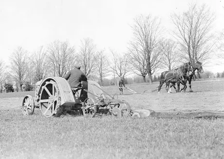 Ploughing with tractor and horse