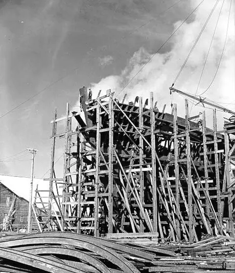 Prince Rupert dry dock and shipyard : fabricated steel plates and beams surround bow of cargo vessel