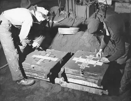Prince Rupert shipyard : in foundry of Prince Rupert shipyard, workmen prepare moulds for brass ship fittings