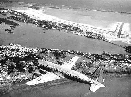 A TCA Canadair DC-4M North Star flying over Kinley Airport, Bermuda