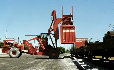 Removing container from flatcar for loading on trucks