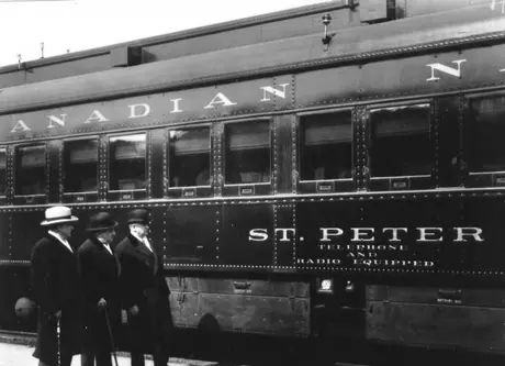 CNR executives beside car equipped for broadcast reception and radio communication