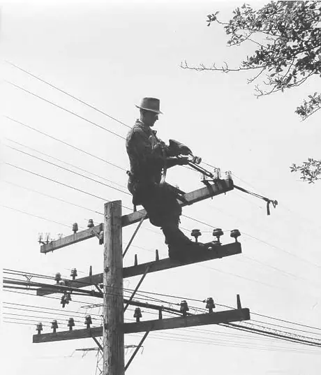 Lineman cuts telegraph wire