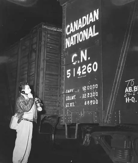 Train crewman communicates by radio