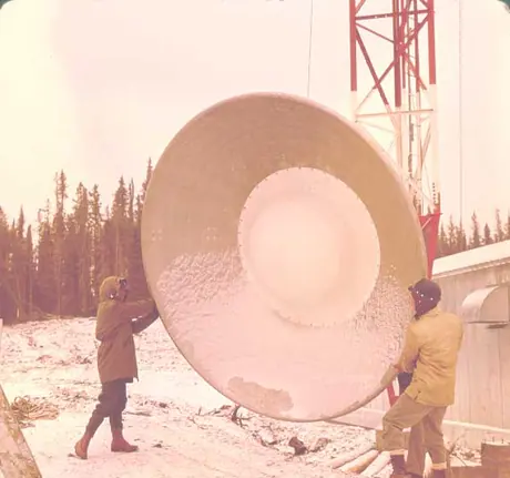 Workers prepare to raise microwave dish