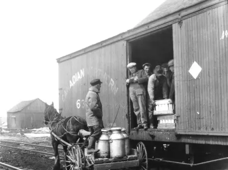 Loading maple syrup into Canadian Northern boxcar