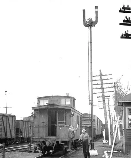 Freight conductor picks up a train-order hoop from a dispatcher