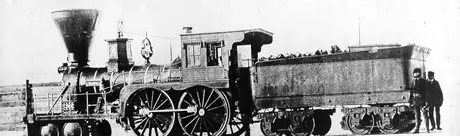 The crew of the Atlantic and St. Lawrence Railroad locomotive Coos pose beside their locomotive on a frigid winter day