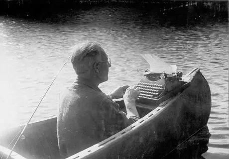 V.B. Gray writing a story in a canoe