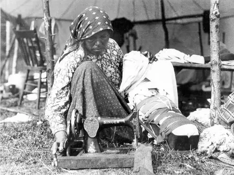 Amerindian woman working Singer sewing machine