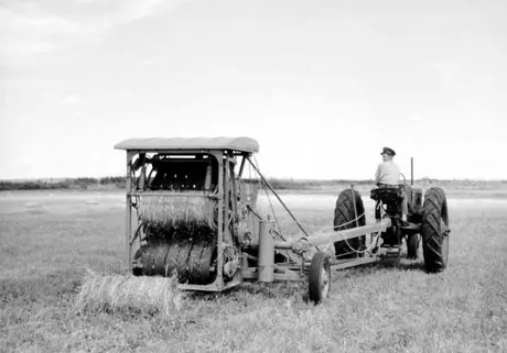 An Allis-Chalmers roto-baler baling hay on the Troisfontaines farm