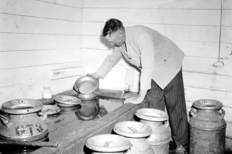Milk cans are kept cool in the Troisfontaines farm's spring house