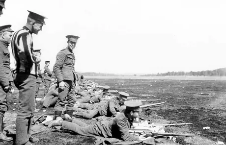 Soldiers lined up to practice shooting at a WWI training camp