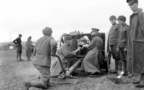 Soldiers load a gun at a WWI training camp
