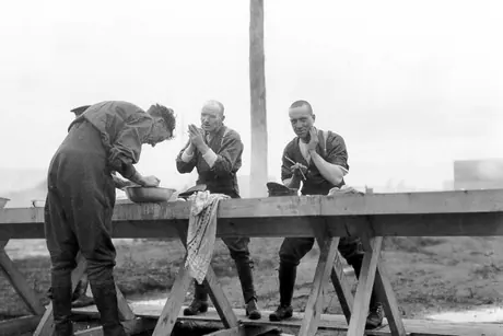 Soldiers shaving at a WWI training camp