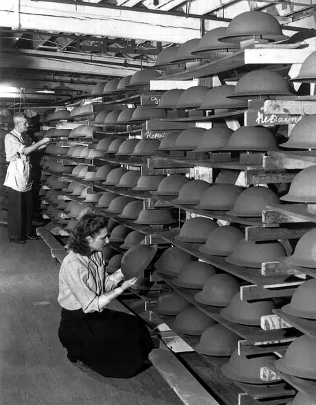 Shelves filled with soldiers' steel helmets at General Steel Wares