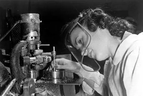 A female machinist working on airplane construction