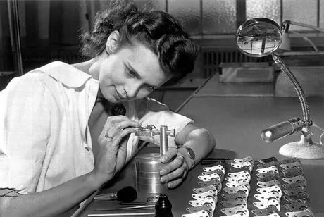 A female worker assembling aircraft parts