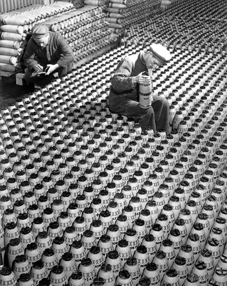 A workman inspects a bomb to be used by the British