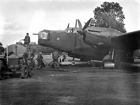 Before take-off, the RCAF ground crew gas up the airplane, check the wireless & engines, & load bombs
