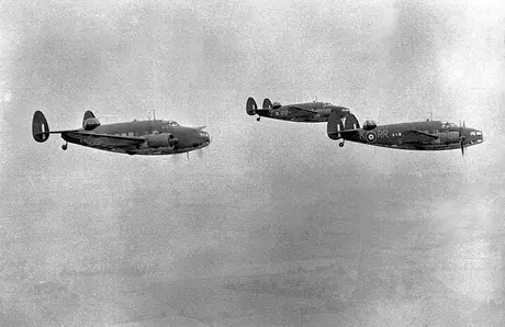 Three Lockheed Hudson aircraft from an RCAF reconnaissance squadron flying out to sea in formation